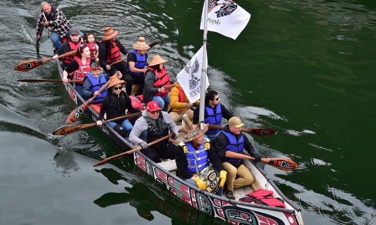 JUNEAU, Alaska (May 4, 2024) - Commander, Navy Region Northwest Rear Adm. Mark Sucato (seated front right) joins Alaskan Natives on the One People Canoe Society's traditional tribal canoe paddle and welcoming ceremony to kick off the annual Juneau Maritime Festival. Sailors assigned to the Arleigh Burke-class guided missile destroyer William P. Lawrence (DDG 110) and Navy Band Northwest are taking part in a scheduled port visit to the capital city of Alaska. (U.S. Navy photo by Chief Mass Communication Specialist Gretchen Albrecht)