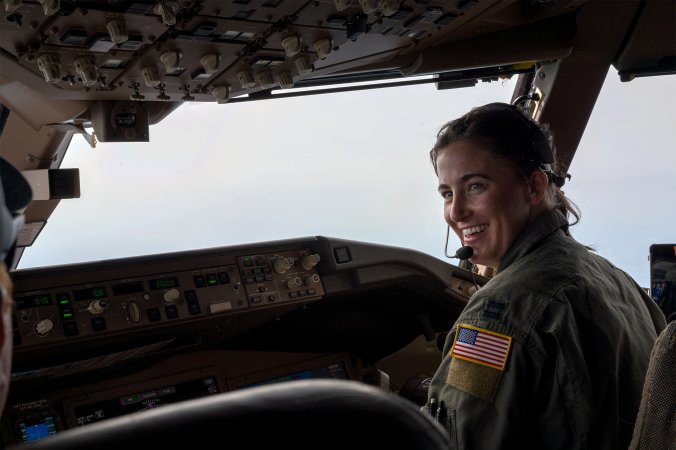 U.S. Air Force Capt. Elizabeth "Sully" Brakefield, 344th Air Refueling Squadron pilot, smiles for a photo in the cockpit of a KC-46A Pegasus May 28, 2024, over the midwestern United States. Capt. Brakefield experienced a reunion at 25,000 feet when she refueled her brother's U.S. Navy EA-18 Growler during an aerial refueling mission. (U.S. Air Force photo by Airman 1st Class Gavin Hameed)