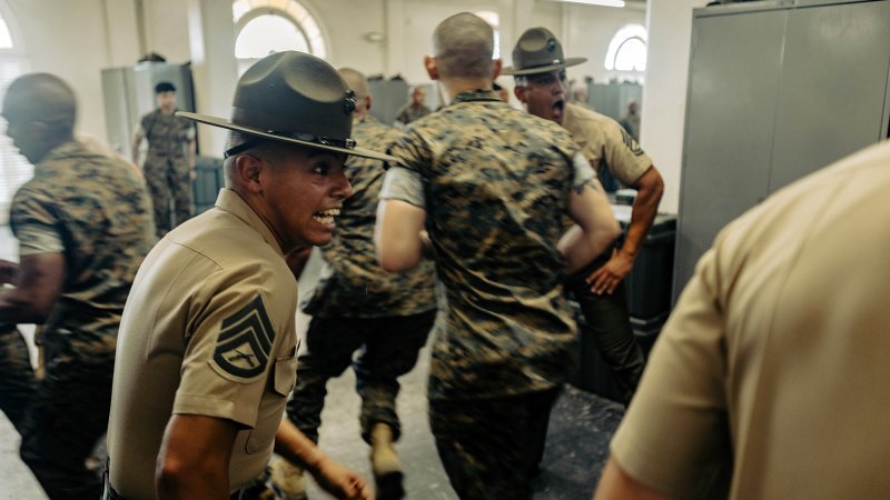 U.S. Marine Corps Staff Sgt. Enrique Dominguez III, an instructor with Marine Corps Recruit Depot San Diego Drill Instructor School, Recruit Training Regiment, directs the new Marines of DI school class 1-25 into a squad bay at Marine Corps Recruit Depot San Diego, California, Oct. 3, 2024. DI school develops leadership, command presence, instructional ability, physical fitness, and professional knowledge in officers and noncommissioned officers to prepare them for the duties of a drill instructor. (U.S. Marine Corps photo by Sgt. Jesse K. Carter-Powell)