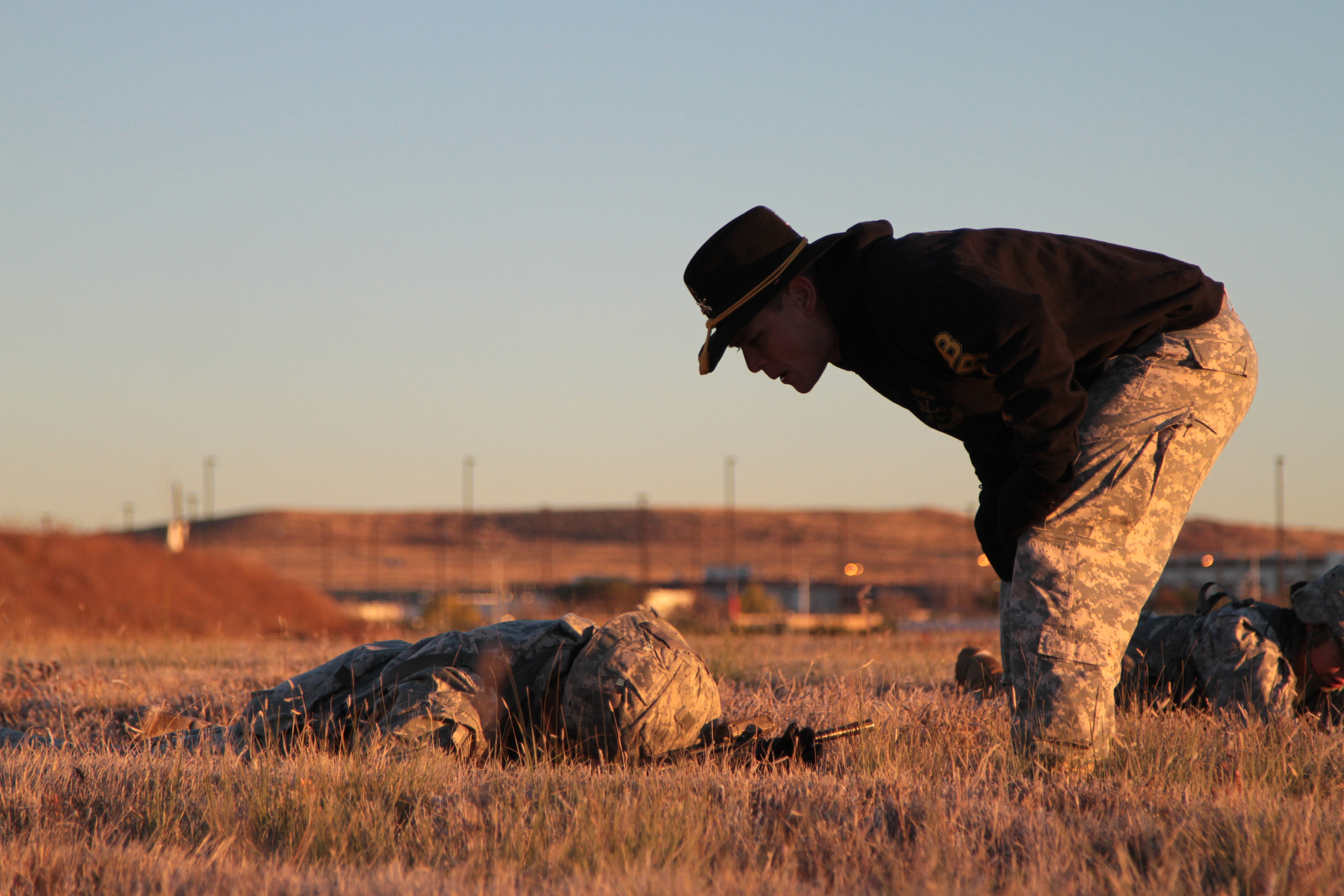 Staff Sgt. Donnie Bass, cavalry platoon sergeant, Battle Troop, 2nd Squadron, 1st Cavalry Regiment, 1st Stryker Brigade Combat Team, 4th Infantry Division, offers guidance on the proper low crawl to a spur candidate during a Spur Ride hosted by the squadron, Oct. 28, 2015. “The yelling that you hear is more corrective training for them, enforcing them to work as a team and achieve the standard,” said Capt. Teodoro C. Garcia, assistant operations, 2nd Sqdn., 1st Cav. Reg., 1st SBCT, 4th Inf. Div.