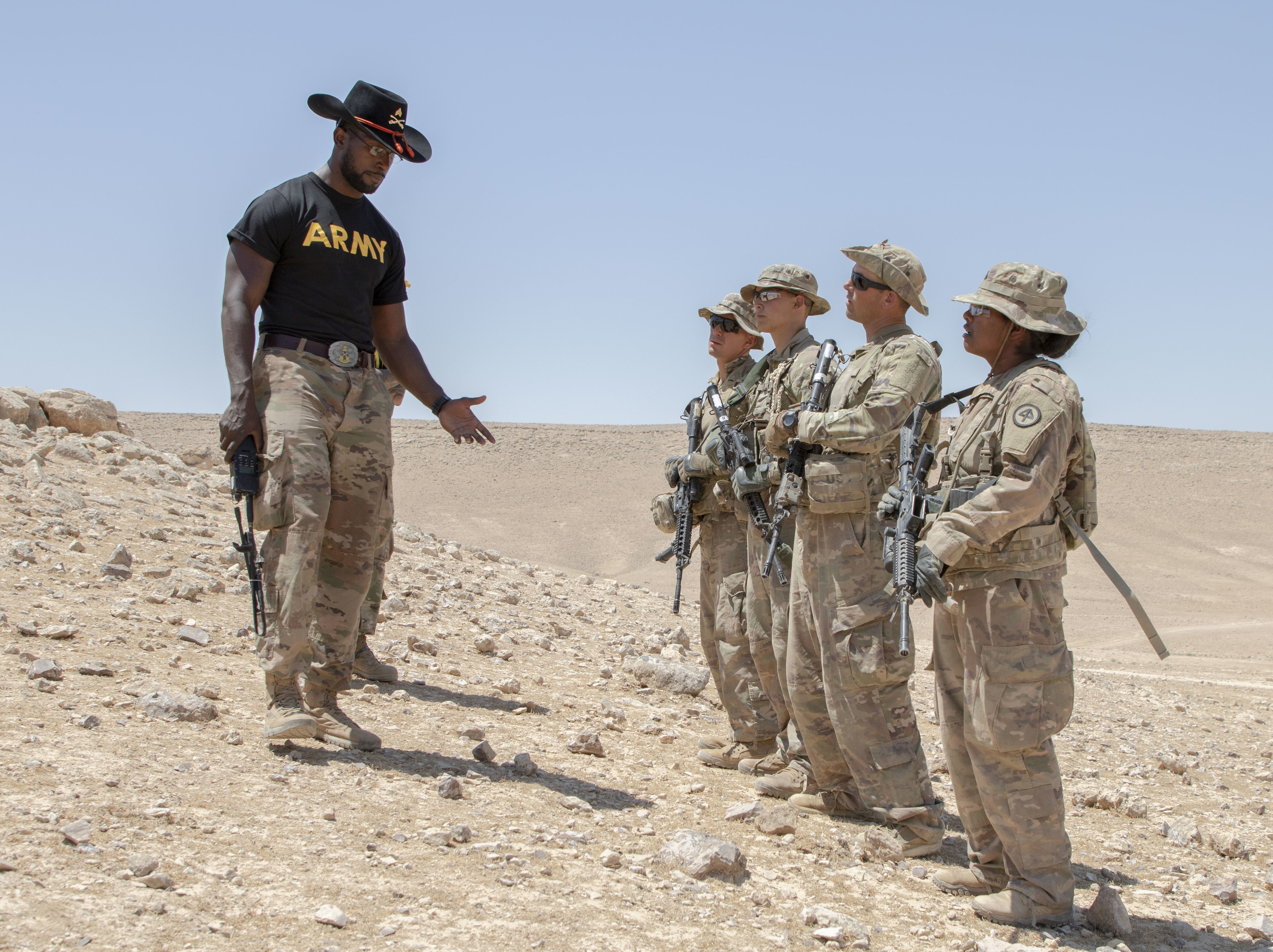 U.S. Army Sgt. Andres Wynter (left), Newark, N.J. resident and spur holder with 1st Squadron, 102nd Cavalry Regiment, 44th Infantry Brigade Combat Team of the 42nd Infantry Division, New Jersey National Guard, instructs spur candidates on their required tasks at his radio communication station during a Spur Ride at Joint Training Center-Jordan August 11, 2019. The Army’s first priority is readiness - ensuring Soldiers have the tools and training needed to be lethal and ready to fight and win. (U.S. Army photo by Sgt. 1st Class Shaiyla B. Hakeem)