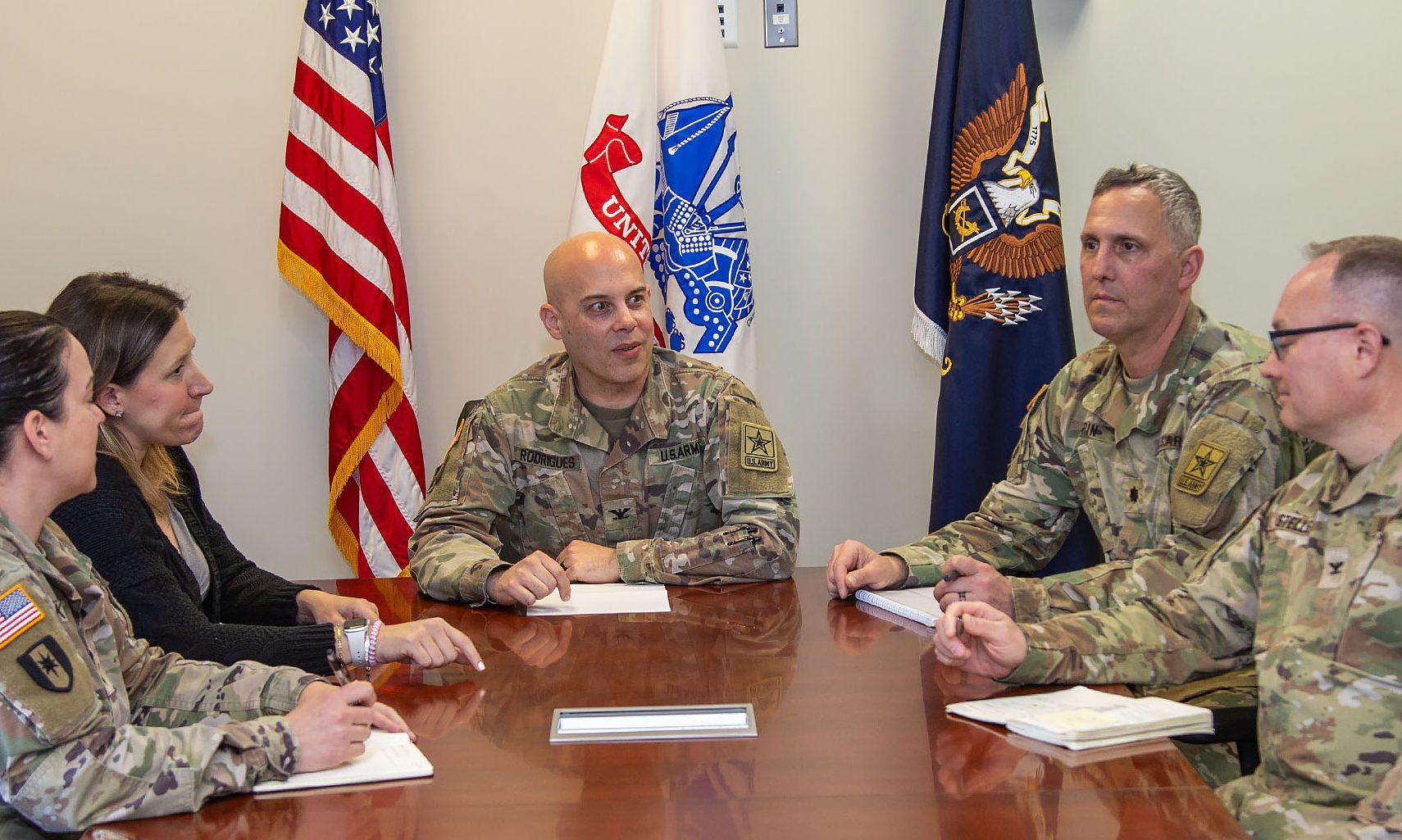 Col. Robert Rodrigues, Acting Lead, Office of Special Trial Counsel, center, confers with his team at Fort Belvoir, VA, April 12 at OSTC headquarters. OSTC has improved U.S. Army justice, as the most serious allegations are moved away from the chain of command, to independent prosecutors. He manages 8 mid-level headquarters and 26 field offices across the Army.