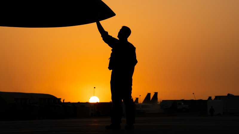 A pilot deployed to the 332d Air Expeditionary Wing, checks an F-15E Strike Eagle during a routine post flight inspection during sunset on the flightline. The F-15s fly combat missions regularly and pilots work closely with maintainers to assure the aircrafts are safe. (Air National Guard photo by Master Sgt. Jonathan Young)