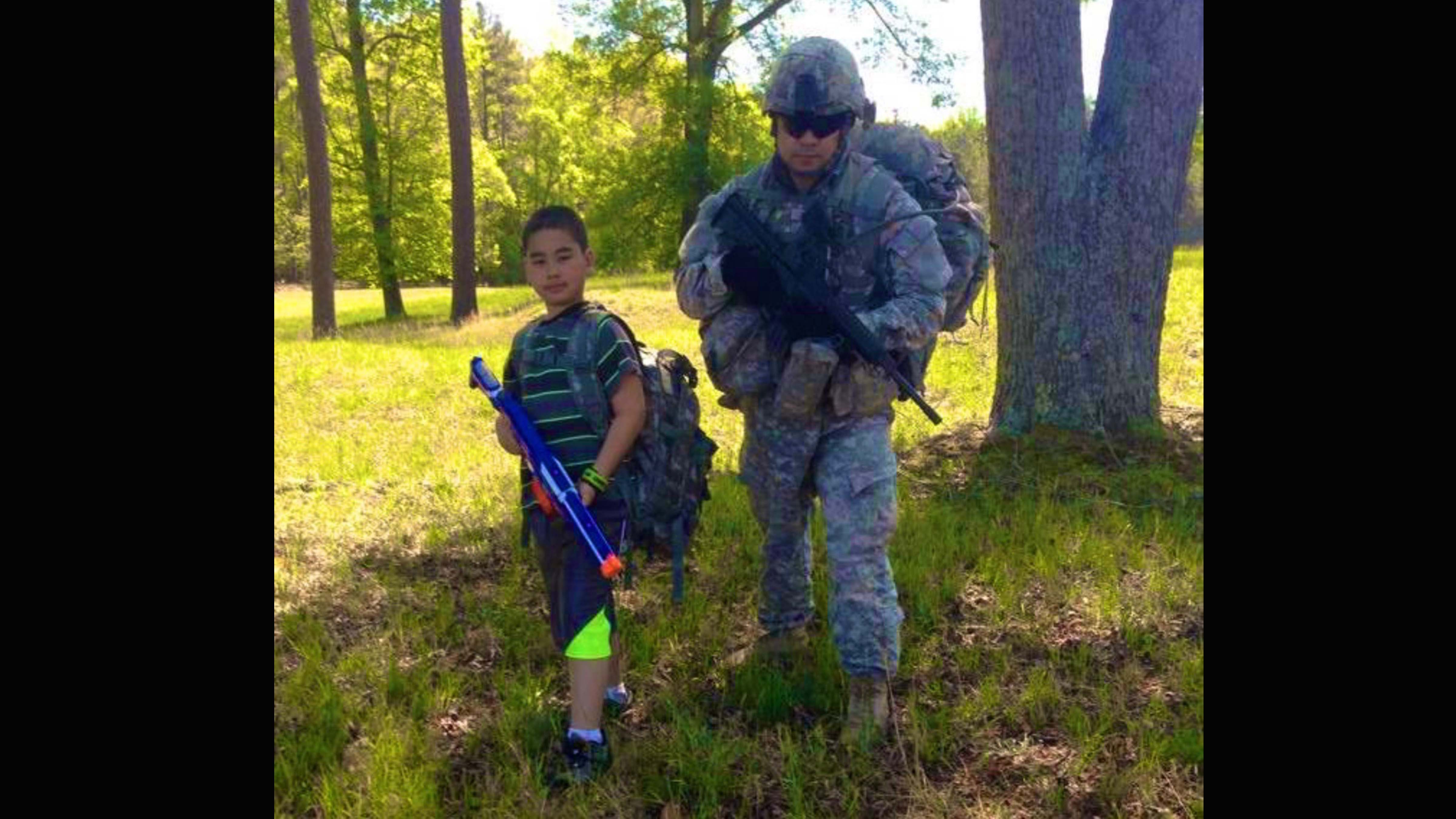 Michael Liscano Jr. and his 8-year-old son, Michael Liscano III, on a ruck march together.