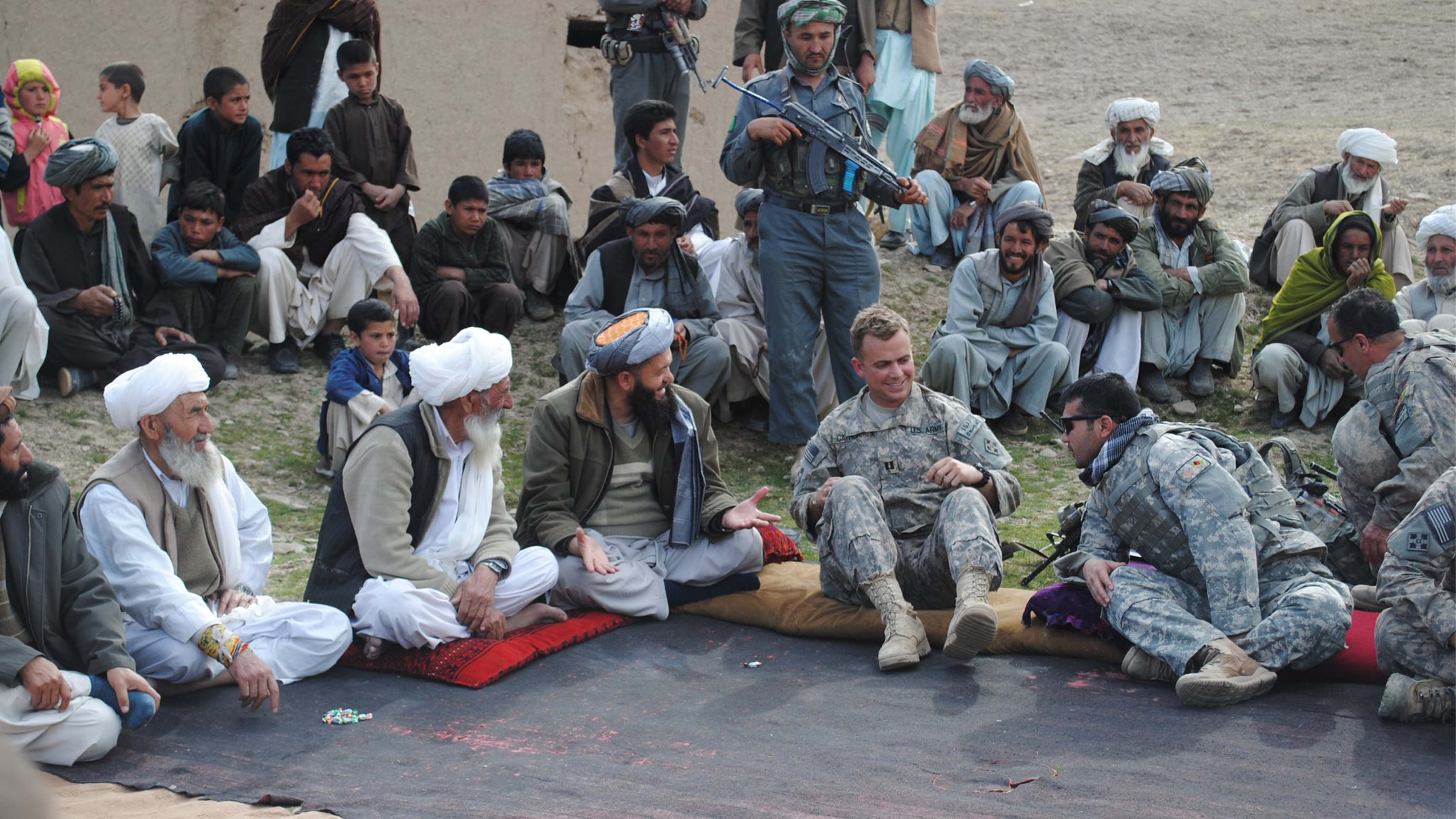 Capt. (then) Garrett Cathcart having a sit down meeting with more Afghan villagers in 2011.