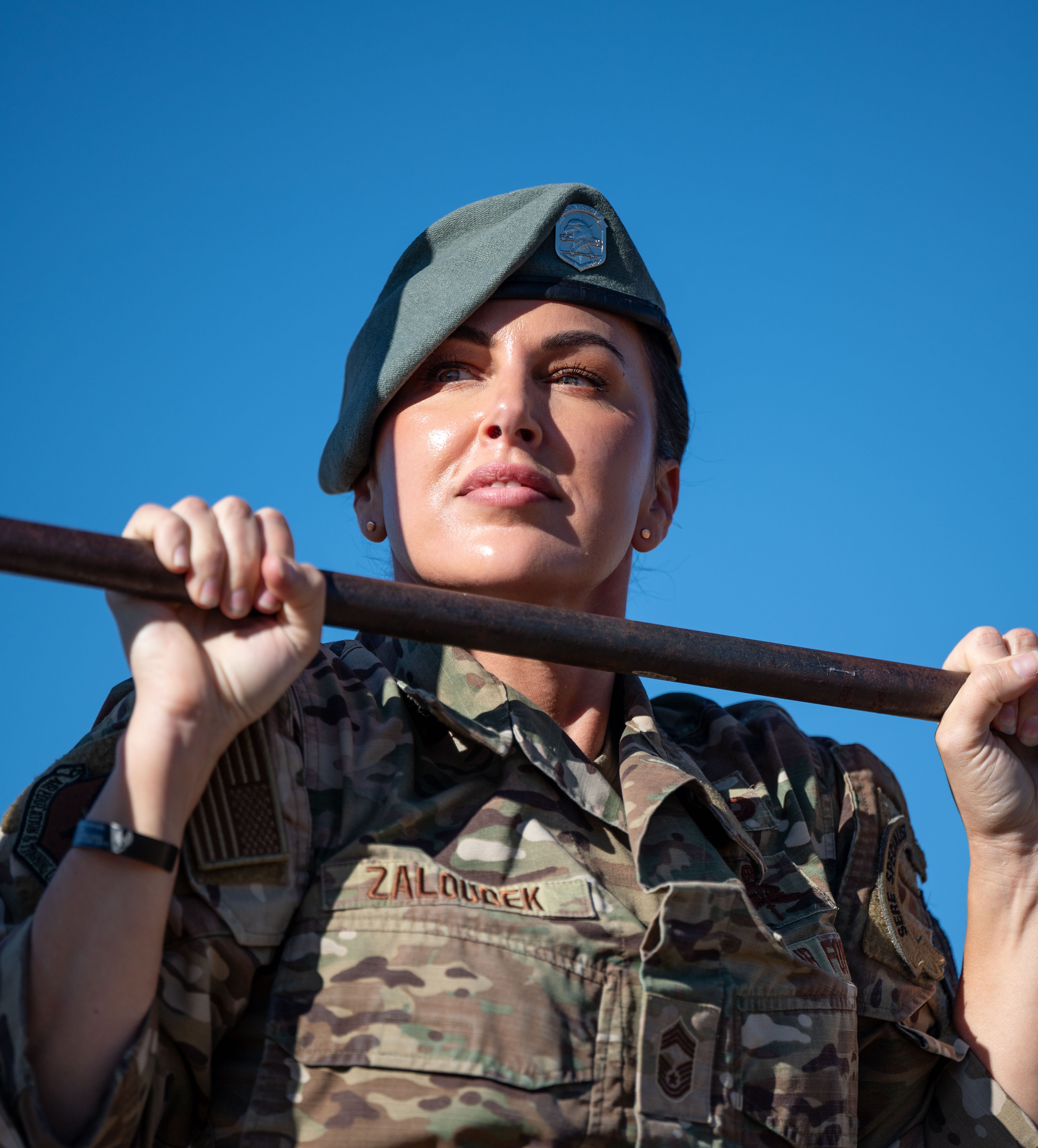 Chief Master Sgt. Tiffany Zaloudek, Deputy SERE Career Field Program Manager, completes rounds of pull-ups on Joint Base San Antonio-Chapman Training Annex, Texas, on Oct. 5, 2024. Zaloudek is the first female SERE Specialist to earn the rank of Chief Master Sgt. and has spent her career proving that women can be both strong and feminine. (U.S. Air Force photo by Miriam Thurber)