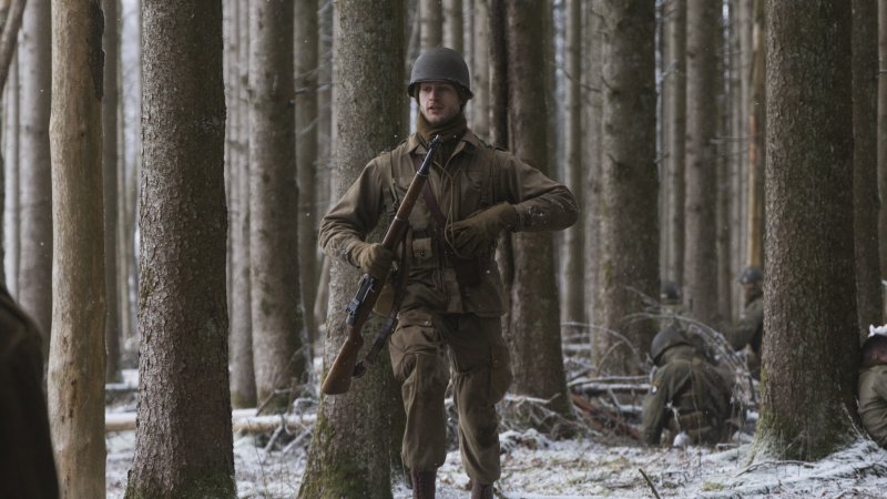 A World War II reenactor marches through the Ardennes Forest on Dec. 14, 2024.