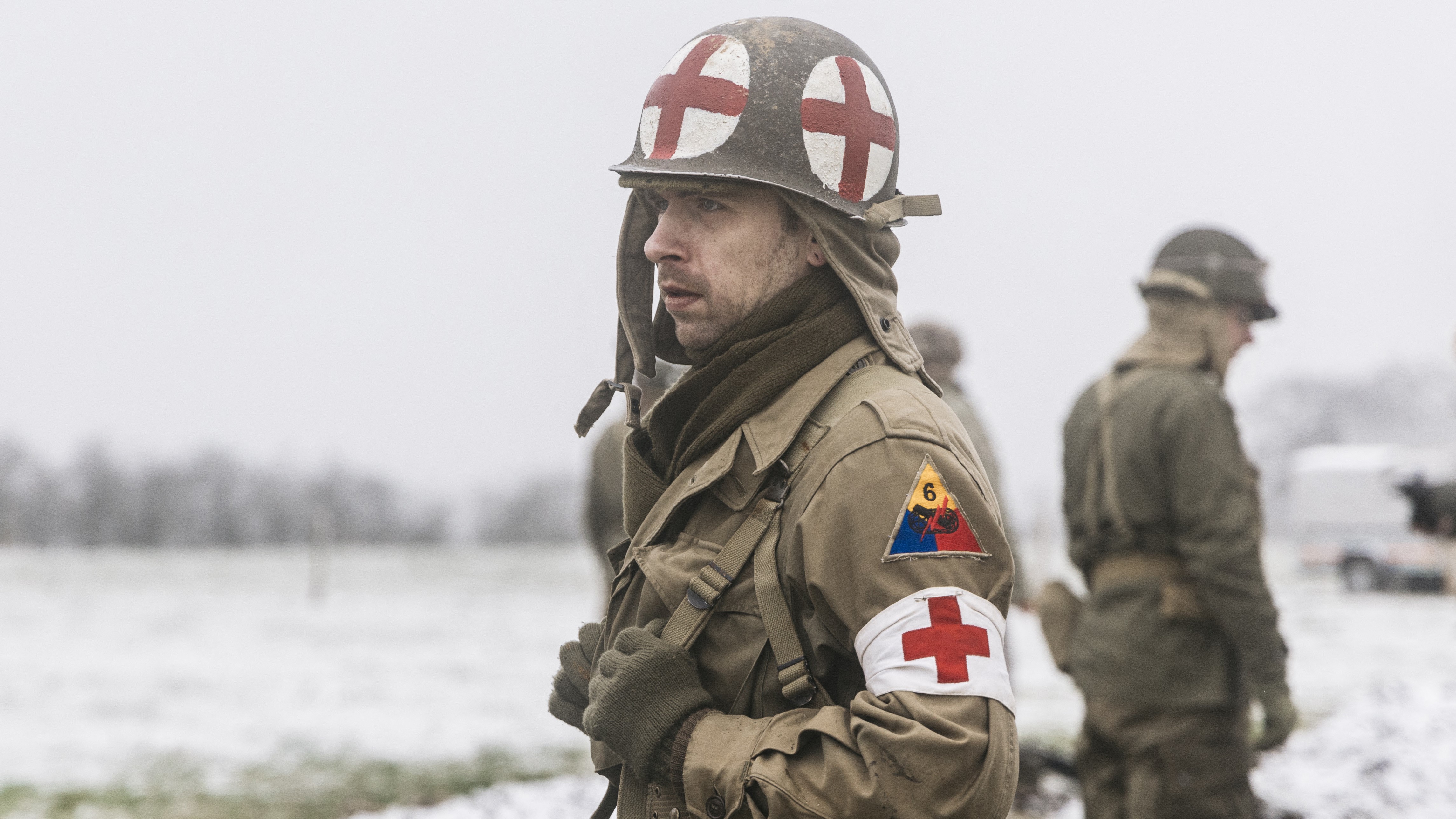 A reenactor dressed as a medic from World War II marches through Bastogne on Dec. 14, 2024.