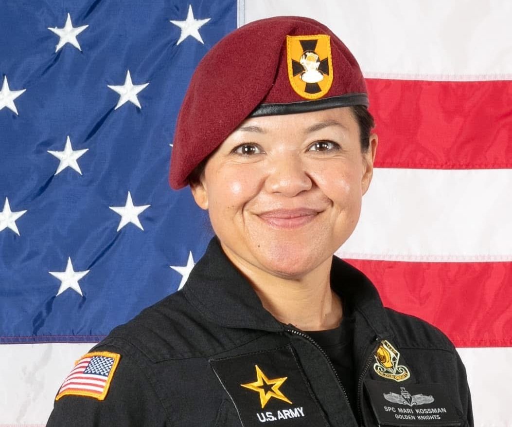 Army Spec. Maribeth Kossman. As part of her role on the Army's Golden Knights, she wears a nametag that includes her Navy Surface Warfare Pin.