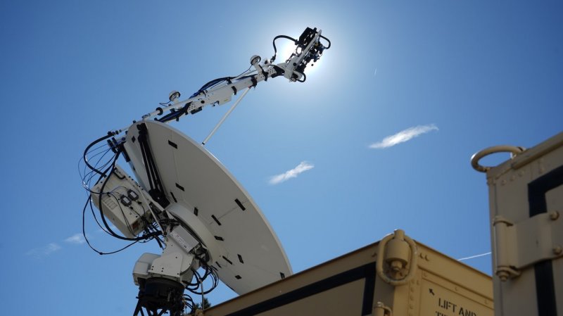 A satellite jammer sits atop a shipping container.