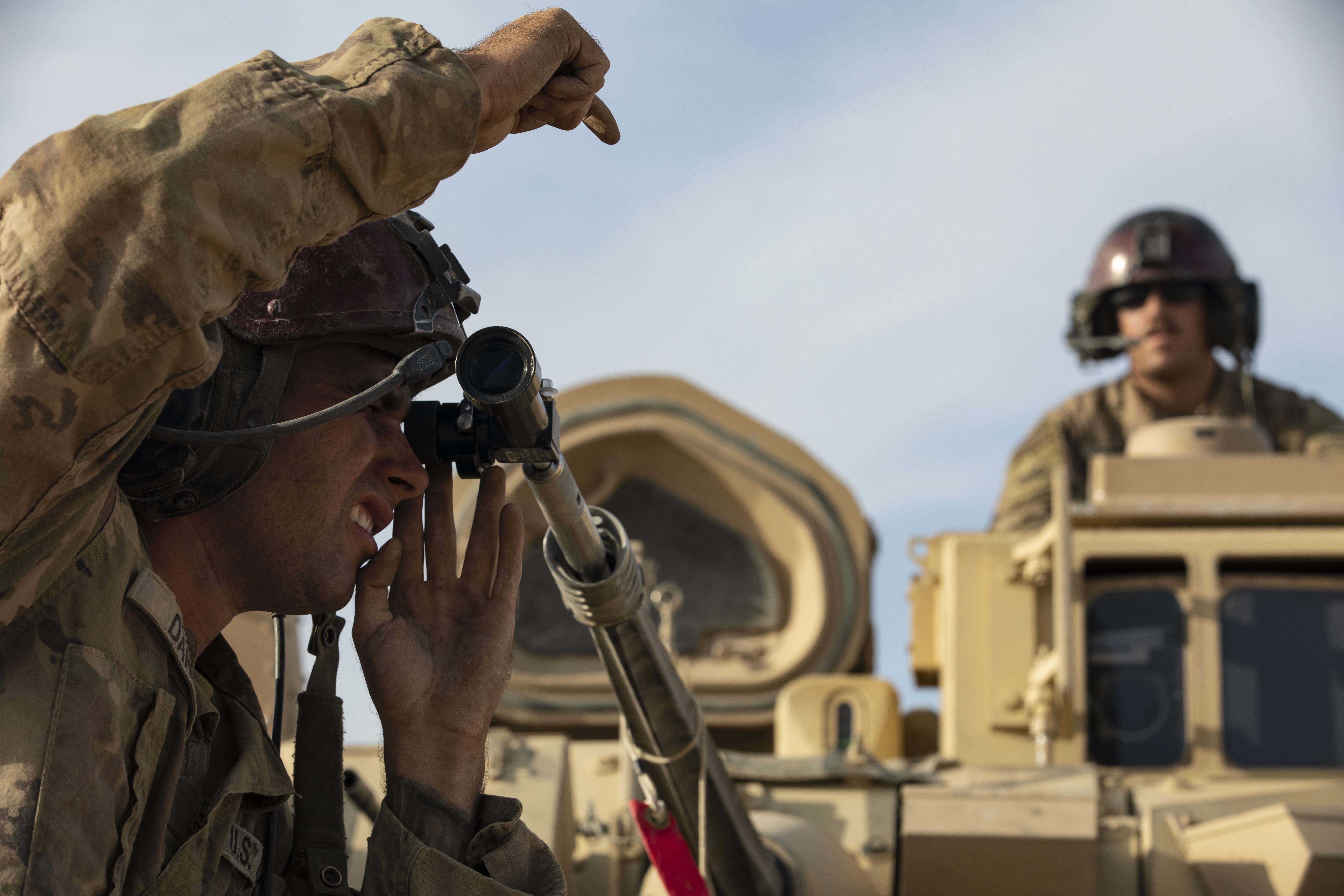 Pvt. Alecsander Daniel (Left) and Sgt. Kyle Angove (Right), with Alpha Troop, 1st Battalion, 6th Infantry Regiment, 2nd Armored Brigade Combat Team, 1st Armored Division, bore-sight their M2 Bradley Infantry Fighting Vehicle in Central Command (CENTCOM) area of responsibility, Oct. 20, 2020. The soldiers are in Syria to support Combined Joint Task Force-Operation Inherent Resolve (CJTF-OIR) mission. CJTF remains committed to working by, with and through our partners to ensure the enduring defeat of Daesh. (U.S. Army photo by Spc. Jensen Guillory)