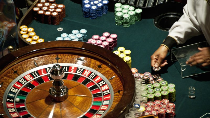 A casino roulette wheel with chips.