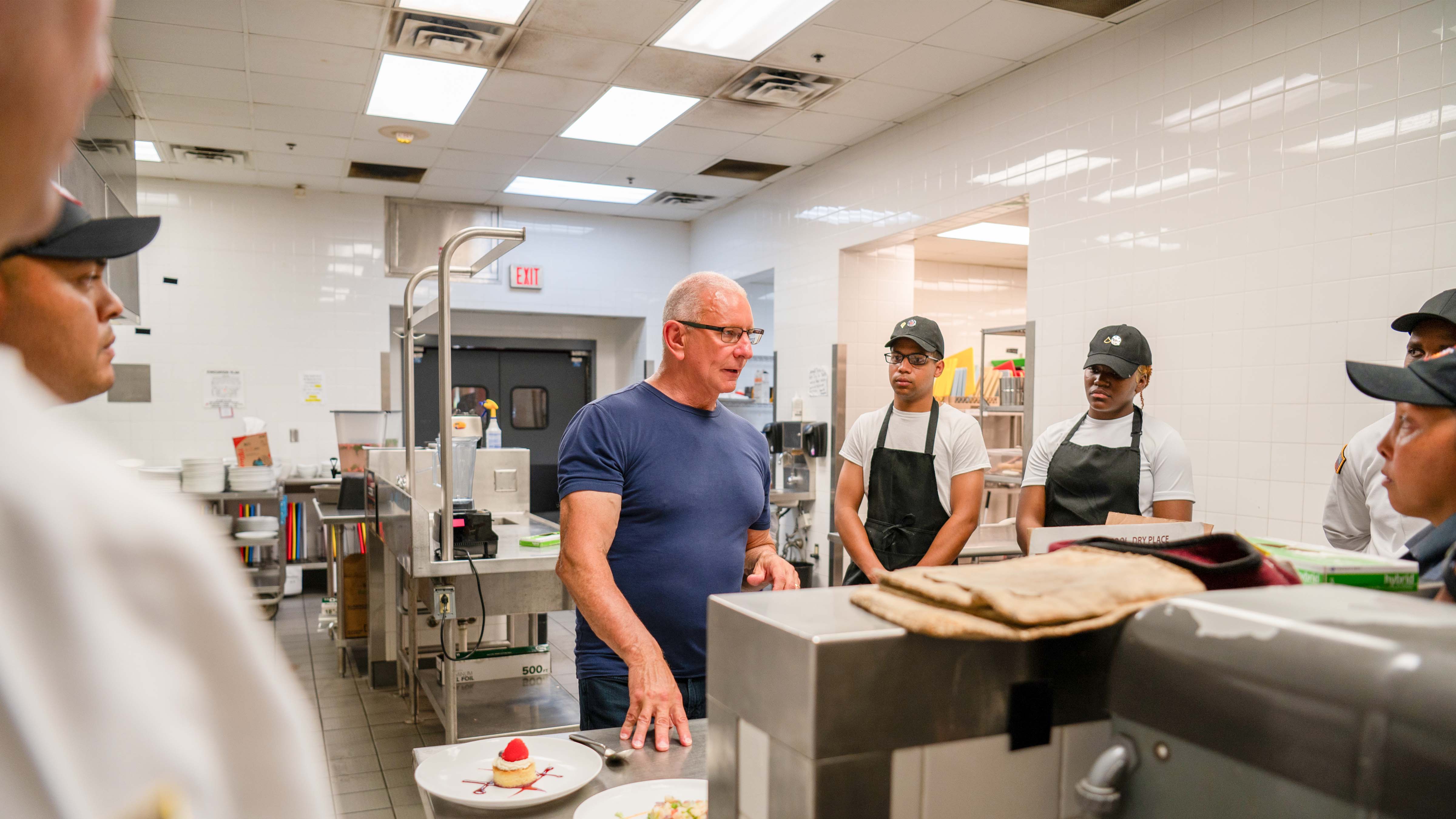 Chef Robert Irvine showing Army culinary specialists how to cook healthy and tasty food at Ft. Liberty.