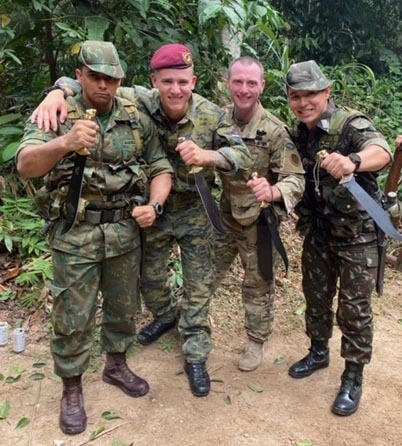 New York Army National Guard Staff Sgt. Thomas Carpenter, second from right, and other Soldiers who graduated from the Jungle Operations International Course conducted by the Brazilian Army Jungle Warfare Training Center, brandish their machetes following a graduation ceremony on Nov. 30, 2019 in Manaus, Brazil. Carpenter was the 30th American Soldier to graduate from the tough, demanding course. (Courtesy photo)