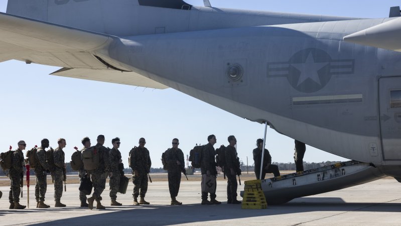 U.S. Marines with 1st Battalion, 6th Marine Regiment, 2d Marine Division board a C-130 Hercules on Marine Corps Air Station New River, North Carolina, Feb. 1, 2025. The Marines are deploying in support of the Department of Defense and Department of Homeland Security mission to expand the Migrant Operations Center at Naval Station Guantanamo Bay. (U.S. Marine Corps photo by Lance Cpl. Alexandria Serrano)