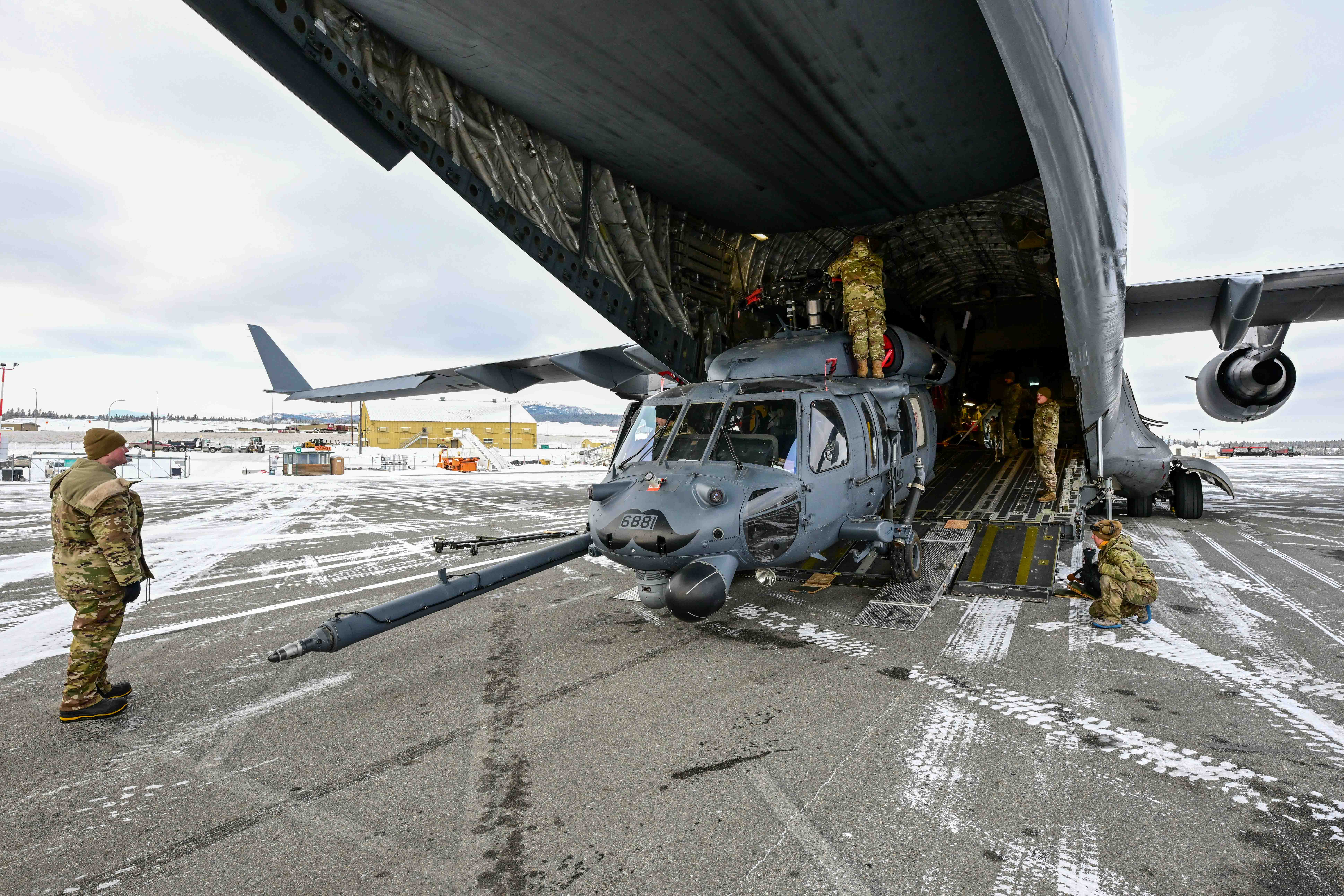 Alaska Air National Guard Airmen of 176th Wing load a 210th Rescue Squadron HH-60G Pave Hawk at Whitehorse, Yukon Territory, Canada, for a Feb. 5, 2025, transport to Joint Base Elmendorf-Richardson, Alaska. The HH-60’s crew and 212th Rescue Squadron pararescuemen rescued two victims of a Jan. 26 ultralight plane crash near Faro, Yukon Territory, Canada. (Photo courtesy of Simon Blakesley)