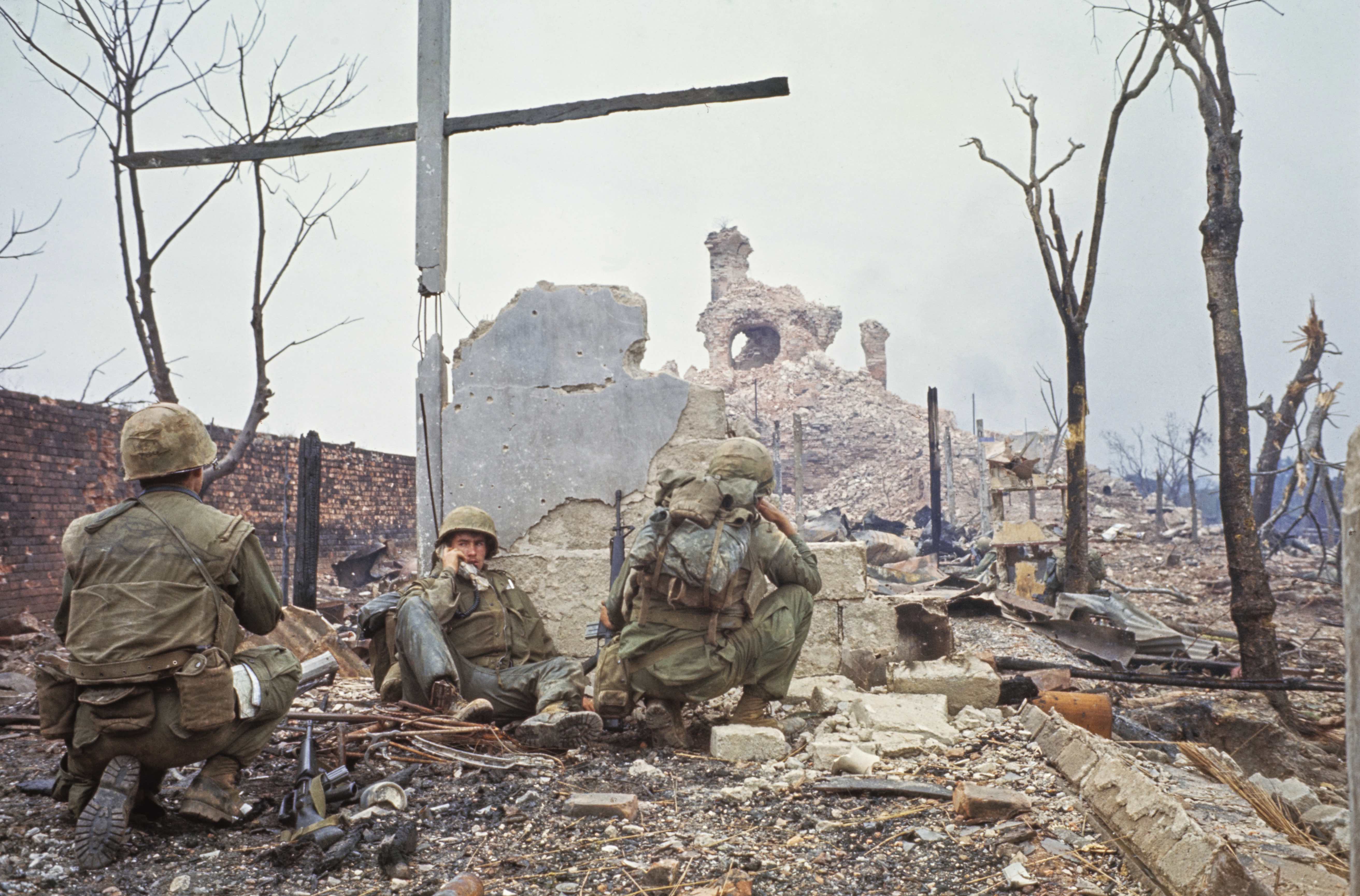 United State Marines among the ruins of a house that was levelled by Marines who determined that Communists were taking refuge inside, in Hue, Vietnam, 15th February 1968. (Photo by Bettmann Archive/Getty Images)