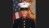 A headshot of a Marine in full dress, with the American flag behind him.