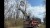 A ladder truck from the Edinburgh, IN fire department reaches a paratrooper in a tree on Camp Atterbury.