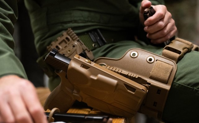 U.S. Air Force members assigned to March Air Reserve Base in Calif., complete a new course of fire qualification for the M18 SIG, April 12, 2024. The enhanced 9mm caliber pistol is a lighter polymer pistol, with a more uniform trigger pull accommodating various hand sizes thereby improving shooter lethality within our diverse force. (U.S. Air National Guard photo by Staff Sgt. Joseph Pagan)