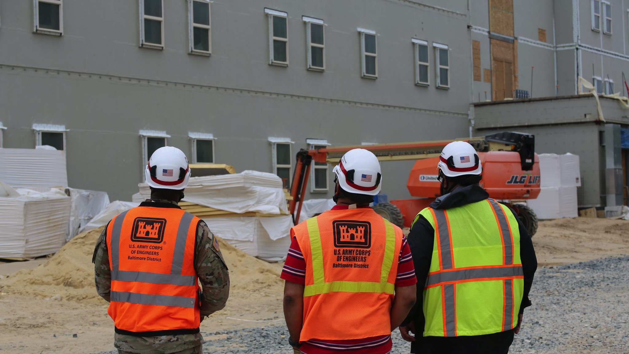 USACE Fort Meade Bay Area Office Project Engineers Marcus Bryant, Melvin Damoudt, and Captain Anthony Adams inspect construction progress at the Freedom Center barracks project, designed to support present and future warfighters. The $38 million development features two multi-story buildings with 190 personnel capacity, offering modern accommodations including living/sleeping rooms with semi-private baths, walk-in closets, and kitchen/living areas. The complex incorporates advanced security through intrusion detection systems and energy monitoring capabilities, reinforcing the Army and NSA's commitment to providing high-quality housing for service members. Scheduled for completion in October 2025, this project represents a significant investment in military readiness and quality of life.