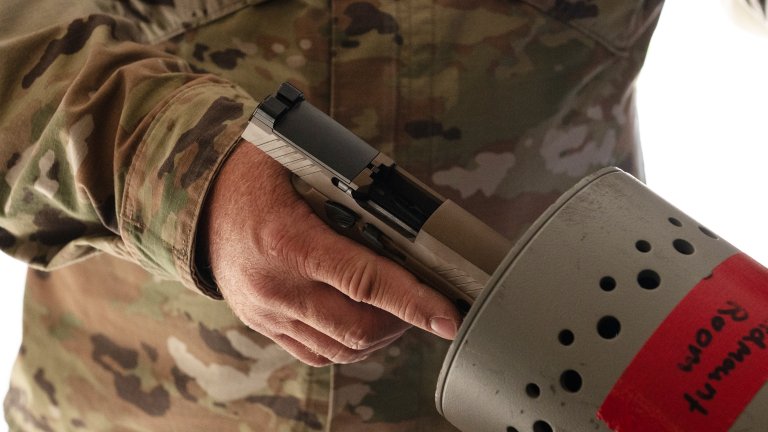 U.S. Air Force Tech. Sgt. Jackie Hamersley from the 205th Engineering Installation Squadron, Oklahoma Air National Guard, clears a SIG Sauer M18 in Camp Ripley, Minn., May 1, 2025. Airmen from the 210th and 205th EIS participated in a joint training exercise that prepared them for future missions while simultaneously completing a multi-year project to install fiber optic cable across the installation to enhance range communications. (U.S. Air National Guard photo by Airman Kaci Brannan)