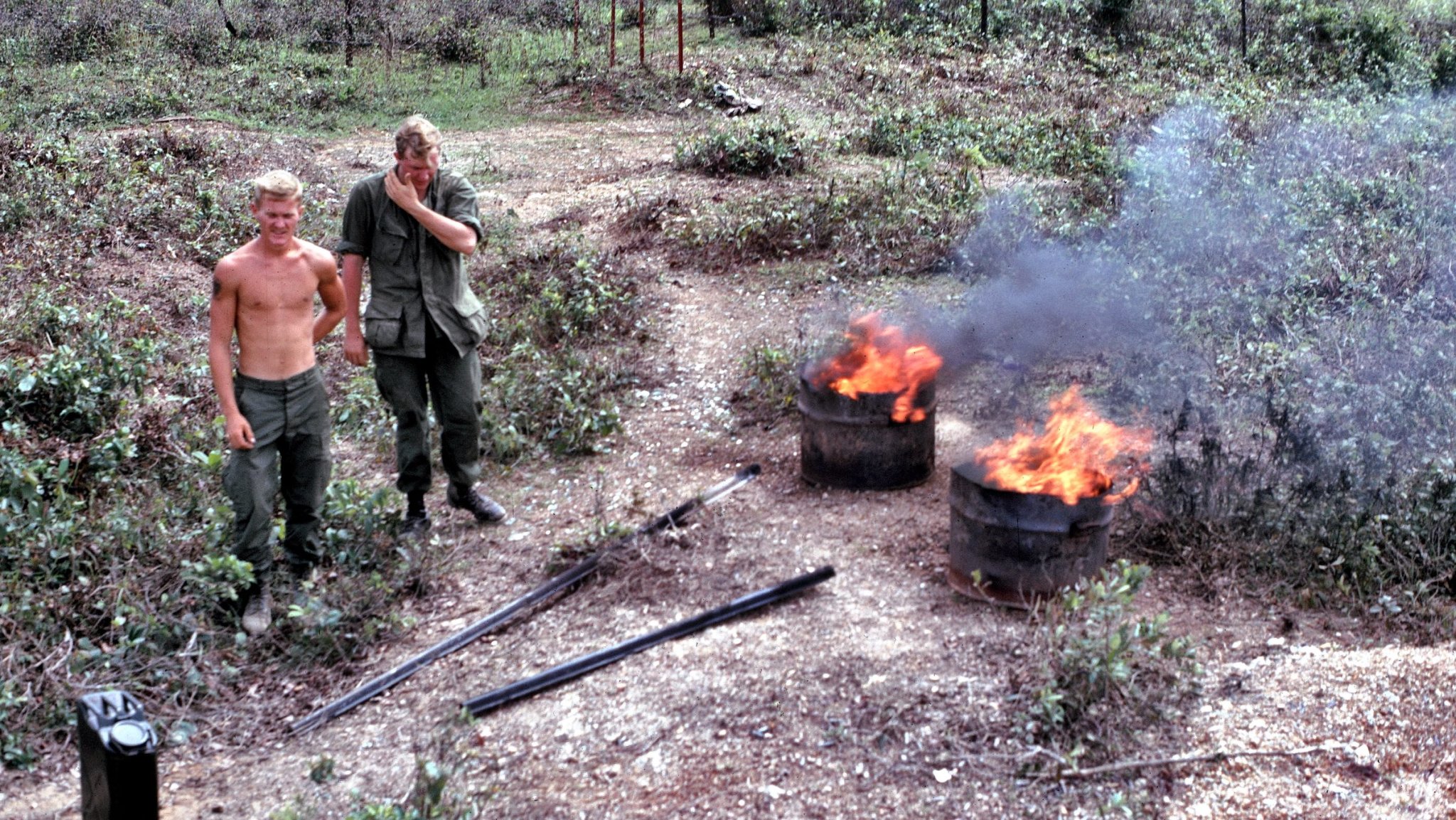 A Combined Action Program Marine and a Navy corpsman using diesel fuel to burn the human waste from Combined Action unit Papa Three's outhouse in Cam Hieu village, Quang Tri Province, Vietnam, on September 20, 1967. (Photo by Ed Palm Photo/Getty Images)