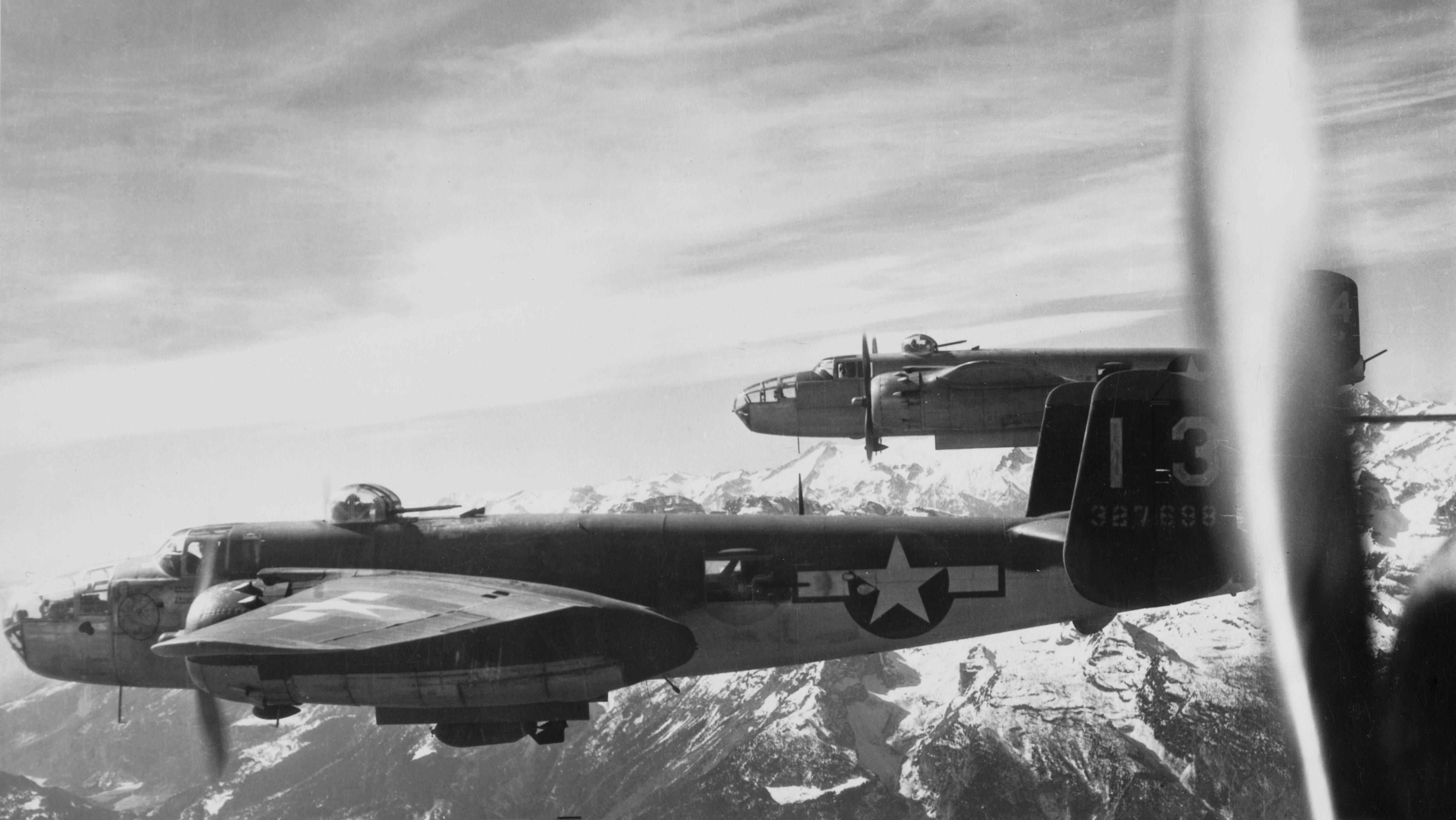 North American B-25 Mitchell Twin engine medium bomber "Peggy Lou" from the 445th Bomber Squadron, 321st Bombardment Group, 57th Bomb Wing of the United States Army Air Forces (USAAF) Twelfth Air Force, drop their payload of 1,000 pound bombs onto Nazi German military positions at the San Michele railroad bridge in the Brenner Pass region of northern Italy on 10th March 1945. US Army Air Force Official Photo. (Photo by 2Lt. Floyd Carlson/Keystone/Hulton Archive Photos/Getty Images).