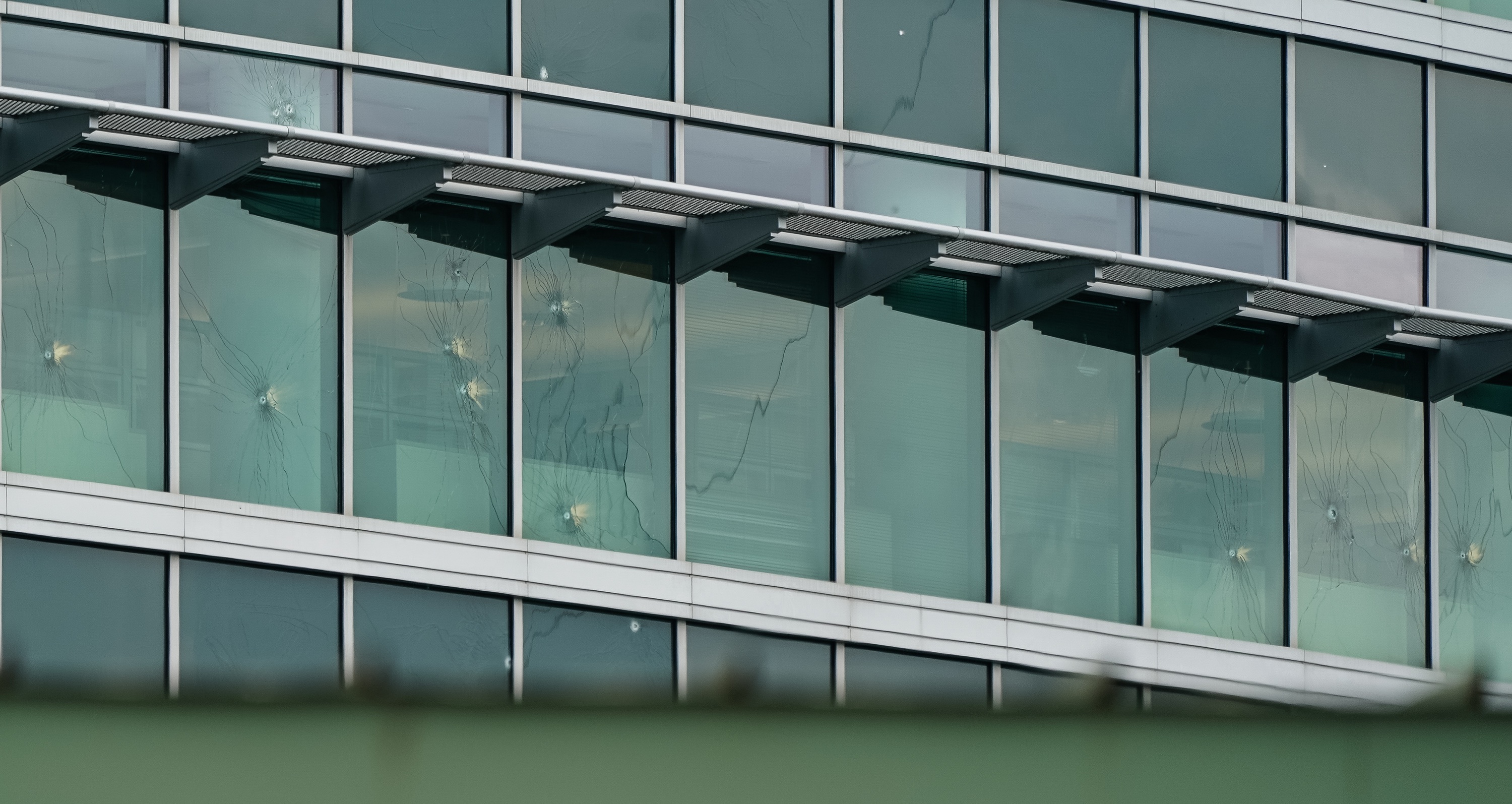 ATLANTA, GEORGIA - AUGUST 9: Bullet holes are seen in windows at the Centers For Disease Control (CDC) Global Headquarters following a shooting that left two dead, on August 9, 2025 in Atlanta, Georgia. (Photo by Elijah Nouvelage/Getty Images)