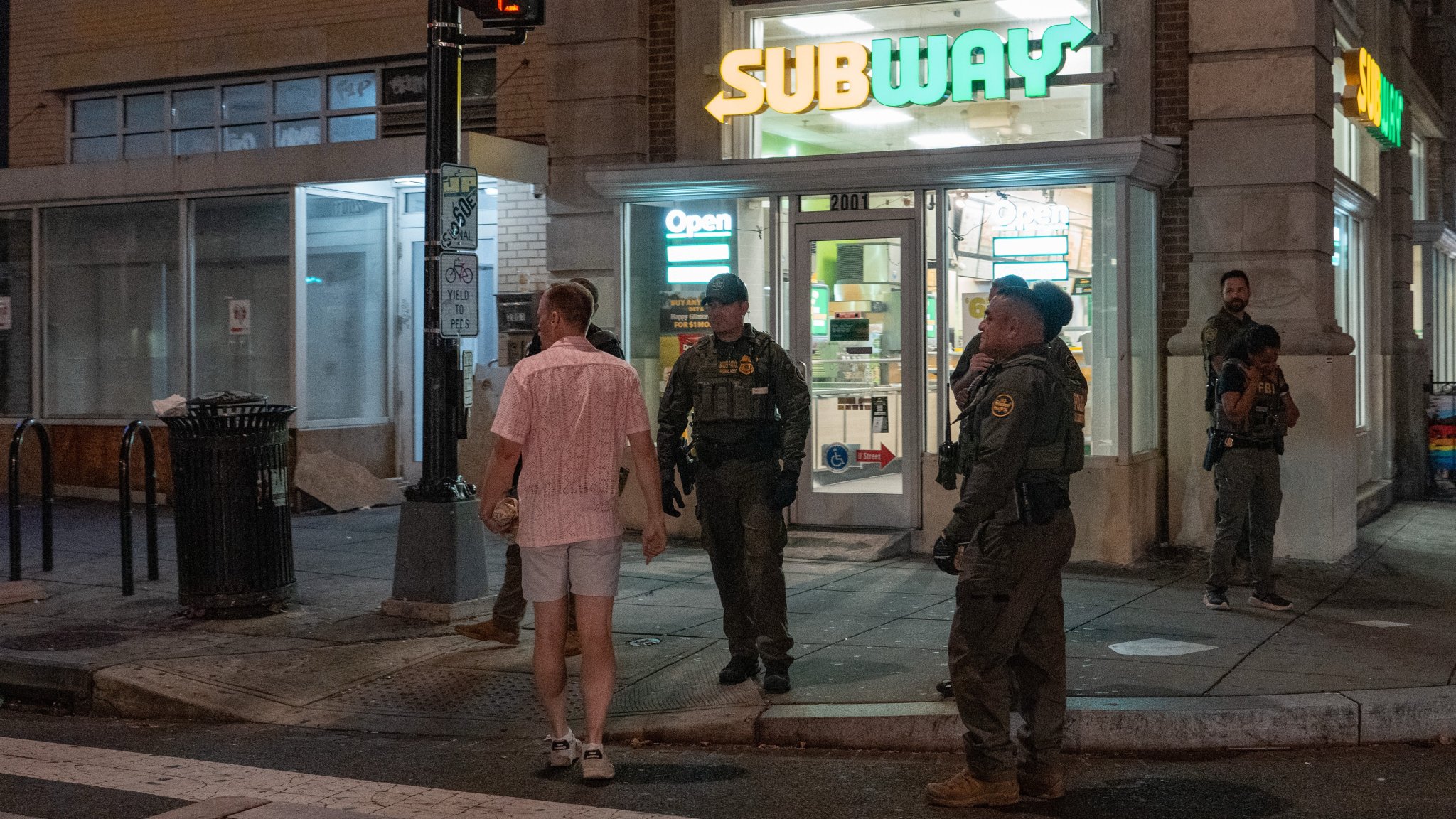 A man, who was later arrested for assaulting law enforcement with a sandwich, interacts with Border Patrol and FBI agents along the U Street corridor on August 10, 2025, in Washington, DC. U.S. President Donald Trump ordered an increased presence of federal law enforcement to Washington, DC in an effort to curb crime. (Photo by Andrew Leyden/Getty Images)