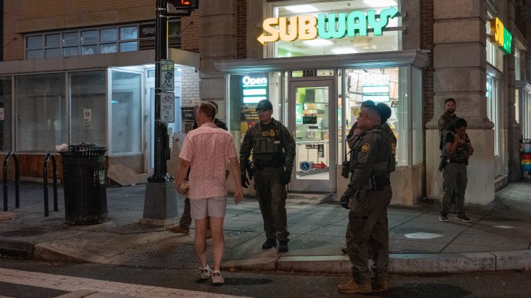 A man, who was later arrested for assaulting law enforcement with a sandwich, interacts with Border Patrol and FBI agents along the U Street corridor on August 10, 2025, in Washington, DC. U.S. President Donald Trump ordered an increased presence of federal law enforcement to Washington, DC in an effort to curb crime. (Photo by Andrew Leyden/Getty Images)