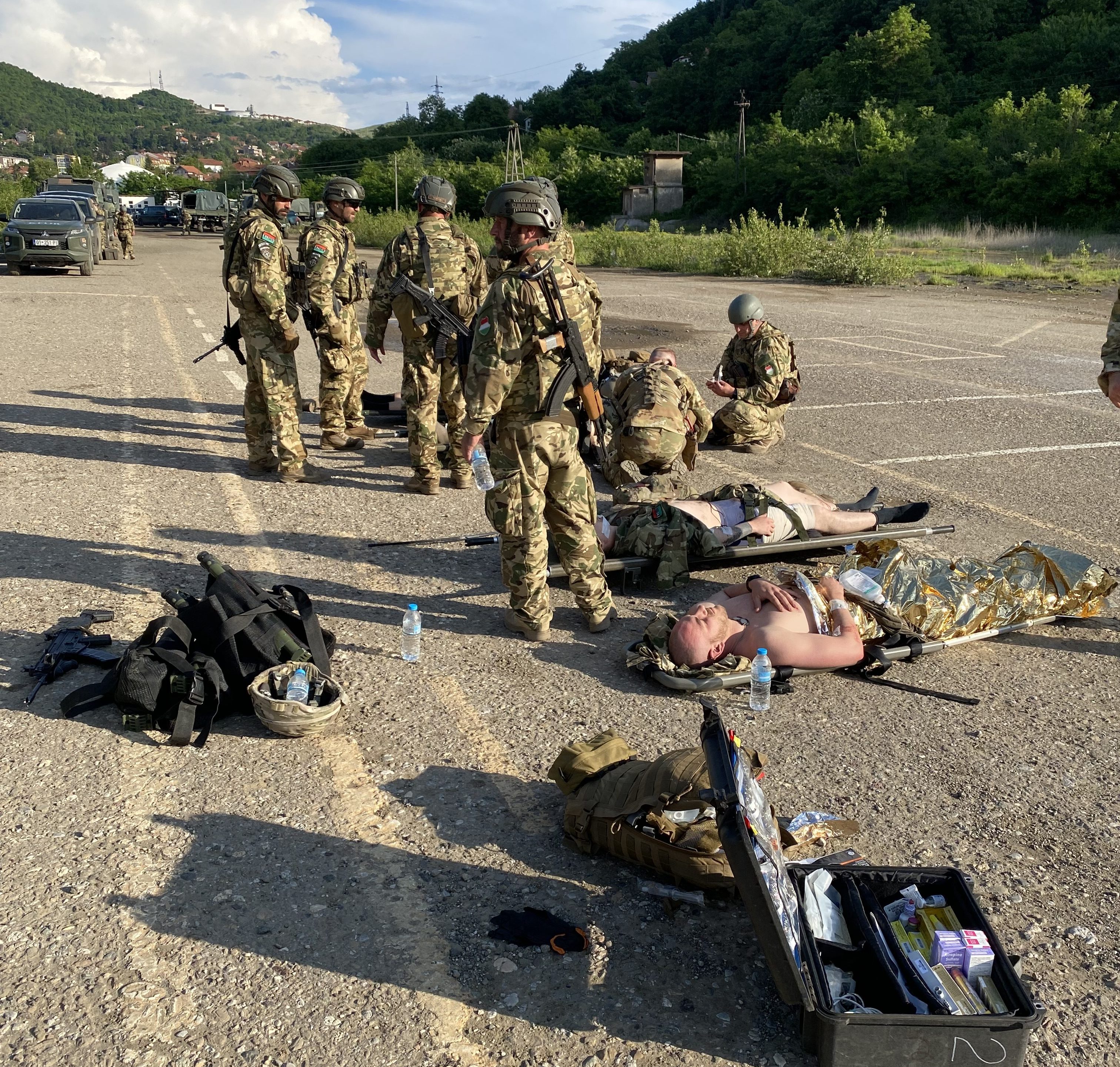 UN peacekeepers wait for ambulances and helicopters at a hasty landing zone U.S. troops established outside Zvecan, Kosovo after 93 soldiers were injured in a May 29, 2023 riot.