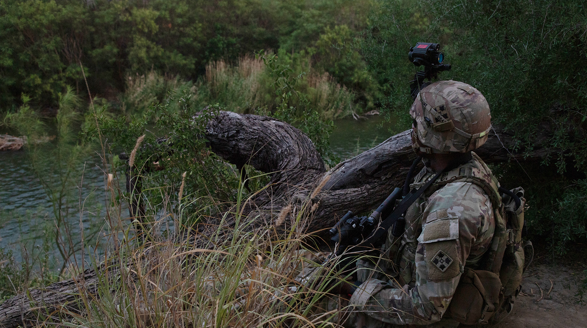 U.S. Army Spc. Gino Exume, assigned to Charlie Company, 1st Battalion, 41st Infantry Regiment, assigned to Joint Task Force-Southern Border, holds his position along the Rio Grande river while monitoring for illegal activity near Rio Grande City, Texas, June 10, 2025. The company began conducting operations in Rio Grande City to help curb illegal crossings into the United States where U.S. Border Patrol reported an influx of illegal activity. Under the direction of U.S. Northern Command, Joint Task Force–Southern Border aligns efforts to seal the southern border and repel illegal activity and is responsible for full-scale, agile, and all-domain operations, which will allow for more effective and efficient DoD operations.