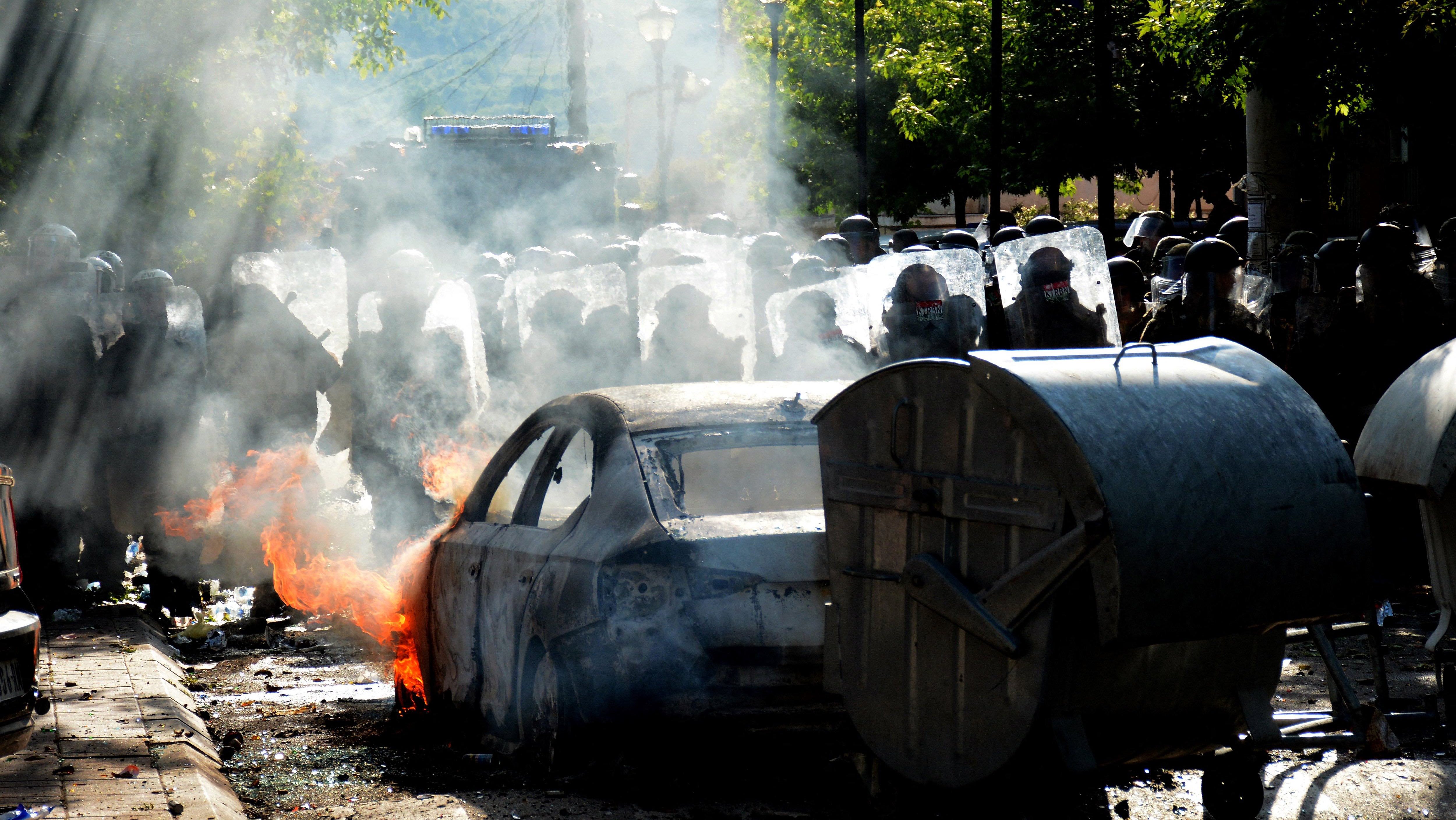 TOPSHOT - Kosovo riot police and KFOR (International Military Mission to Kosovo) military police, secure entrance to municipal building in Zvecan, northern Kosovo on May 29, 2023, following clashes with Serb protesters demanding the removal of recently elected Albanian mayors. NATO-led peacekeepers on Monday dispersed Serb protesters who again clashed with police in northern Kosovo to demand the removal of recently elected Albanian mayors, as ethnic tensions flared in the Balkan nation. (Photo by AFP) (Photo by -/AFP via Getty Images)
