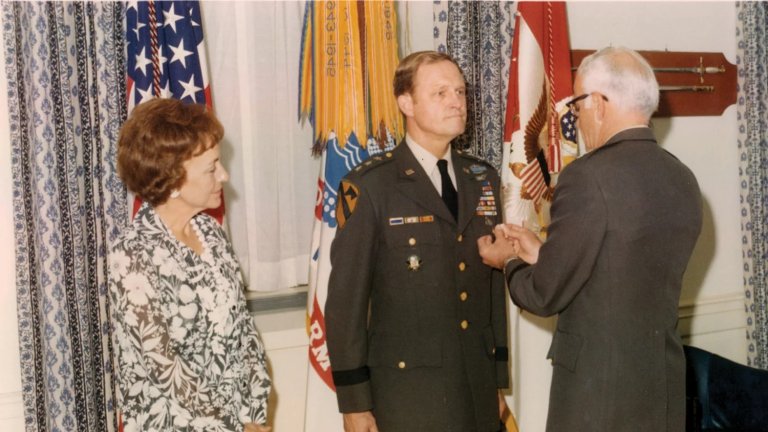 Julia Moore watches Lt. Gen. Hal Moore at his retirement ceremony in 1977.