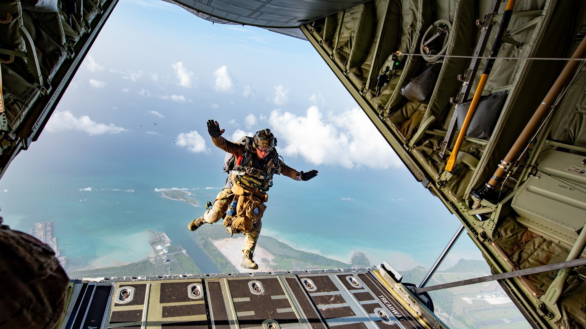 An airman assigned to the Kentucky Air National Guard's 123rd Airlift Wing jumps above Henry E. Rohlsen Airport near Christiansted in St. Croix, U.S. Virgin Islands, Aug. 26, 2025, as part of Emerald Warrior 25.2, a large-scale special operations exercise being staged in multiple locations by Air Force Special Operations Command.