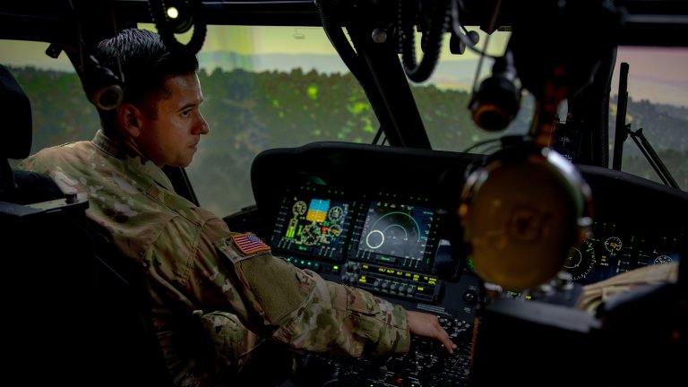 Warrant Officer 1 Alan Ortiz, a UH-60 Blackhawk pilot assigned to 2nd Battalion, 25th Aviation Regiment, 25th Combat Aviation Brigade, trains in a flight simulator at Wheeler Army Airfield, Hawaii, August 25, 2025. The flight simulator is a tool that creates realistic scenarios to practice complex maneuvers and emergency procedures safely. (U.S Army photo by Sgt. Olivia Cowart)