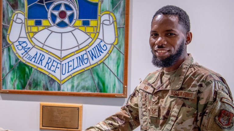 U.S. Air Force Col. Michael S. Albert, 434th Air Refueling Wing commander, Grissom Air Reserve Base, Indiana, coins Tech. Sgt. Abdoulie Bah, 350th Recruiting Squadron recruiter, for breaking a recruiting record by reaching 100 accessions within the 2025 fiscal year, becoming a ’Centurian Club’ recruiter on Aug. 9, 2025, Grissom Air Reserve Base, Indiana. The last time a recruiter accessed 100 or more new Airmen was in 2014 and there have been fewer than 10 to earn the distinction within the past 20 years. (U.S. Air Force photo by Master Sgt. Benjamin Mota)