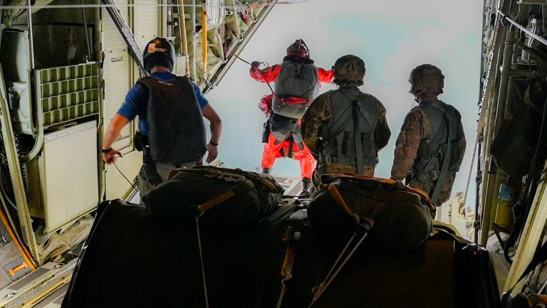 Guardian Angel team members from the 129th Rescue Wing, California Air National Guard, prepare to jump from an HC-130J Combat King II during a long-range maritime rescue mission approximately 885 nautical miles off the California coast. The team parachuted with medical equipment to reach the Panamanian-flagged cargo vessel Grand Vega and stabilize a Filipino mariner suffering stroke-like symptoms. (U.S. Air Force photo by Master Sgt. Joseph Prouse)