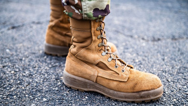 U.S. Air Force Airmen 1st Class Maya Hartung, an admin with the 182nd Command Support Squadron, Illinois Air National Guard, poses for a photo of her boots at the 182nd Airlift Wing in Peoria, Illinois, March 1, 2024. The 182nd Airlift wing operates and maintains C-130 Hercules Aircraft. (U.S. Air National Guard photo by Senior Airman Avery Litton)