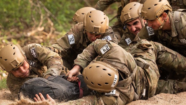 As teams, candidates maneuver an obstacle course during the Special Warfare Training Wing Assessment & Selection Course at Joint Base San Antonio-Lackland on March 14, 2023. The Special Warfare Training Wing prepares candidates physically, mentally, emotionally and cognitively for demanding careers as special warfare operators. (U.S. Air Force photo by Miriam Thurber)