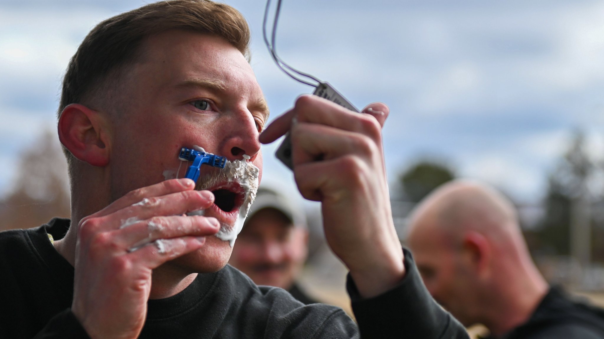 A U.S. Air Force Airman from Fairchild Air Force Base shaves his mustache off during the Mustache Dash event at Fairchild Air Force Base, Washington, March 31, 2023. The Mustache Dash was an event created to raise awareness for mental health that encompasses all four pillars of Comprehensive Airman Fitness, mental, physical, spiritual and social. (U.S. Air Force photo by Airman 1st Class Morgan Dailey)