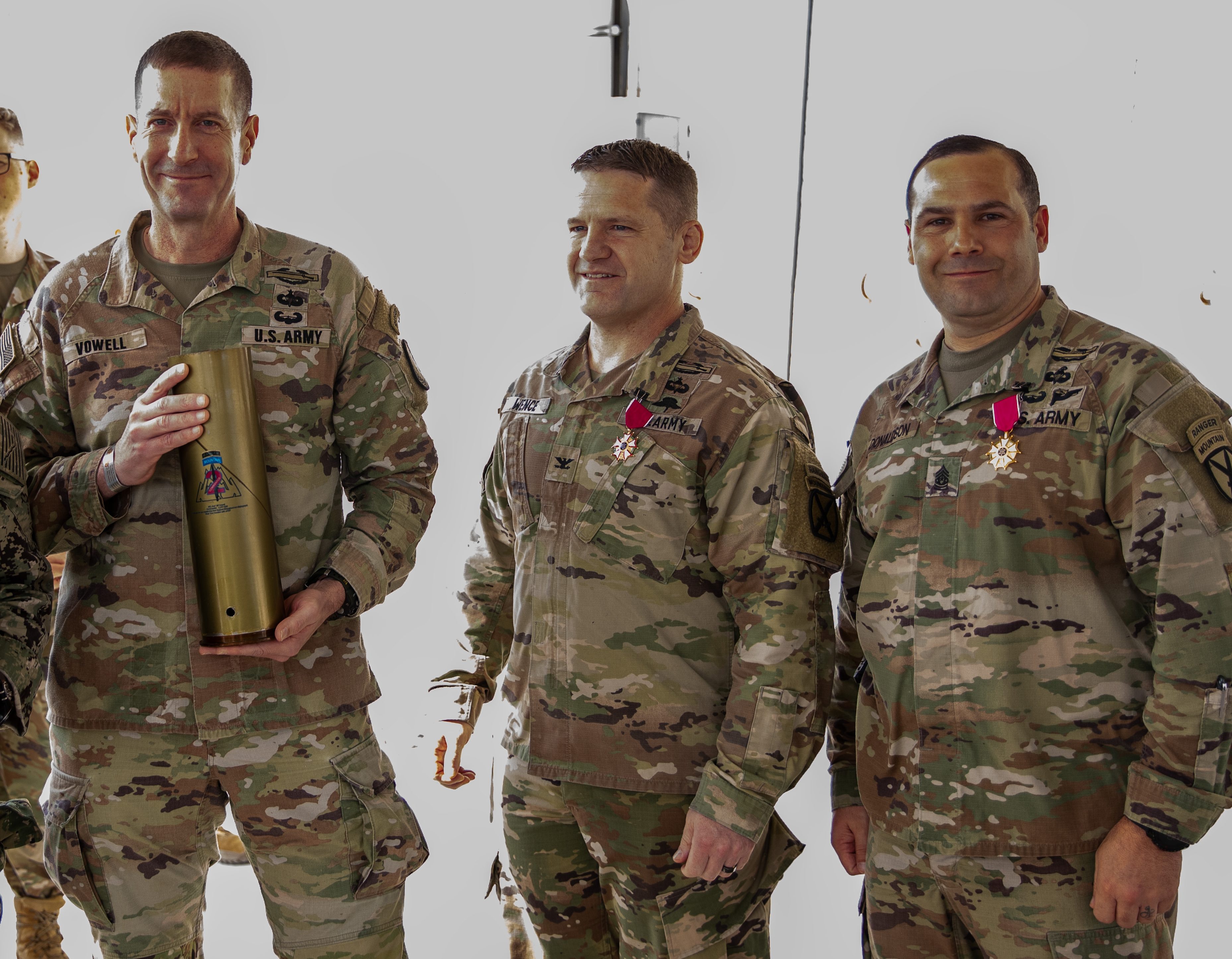 Col. Scott Wence, center, and Command Sgt. Maj. Christopher Donaldson, right, during a command change over at the end of the 2nd Brigade Combat Team's deployment in April 2024.