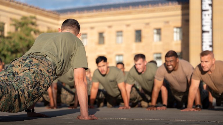 Sergeant Major of the Marine Corps Carlos Ruiz leads Sailors and Marines in cadence pushups at the Philadelphia Museum of Art after a formation run to celebrate the Navy and Marine Corps 250th birthday in Philadelphia, Pa., Oct. 10, 2025. The Navy and Marine Corps returned to Philadelphia, the birthplace of the sea services, to celebrate 250 years of heritage. The anniversary event highlighted advances in military technology and the commitment of service members, while providing the public the opportunity to visit ships and engage with Sailors and Marines while experiencing the hospitality of the City of Brotherly Love. (U.S. Navy photo by Mass Communication Specialist 2nd Class Miguel Santiago)