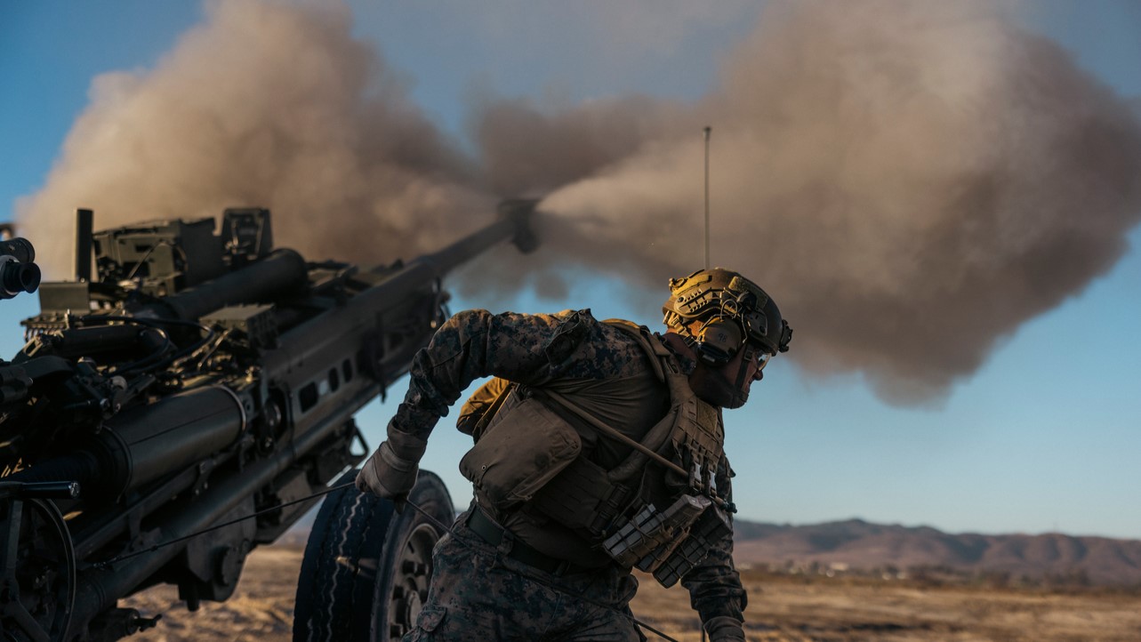 U.S. Marine Lance Cpl. Dashawn M. Rudesill, a cannoneer with 2nd Battalion, 11th Marine Regiment, 1st Marine Division, fires an M777 lightweight 155mm howitzer during a rehearsal for the 250th Amphibious Capabilities Demonstration at Red Beach combat town, Marine Corps Base Camp Pendleton, Oct. 17, 2025. The 250th Amphibious Capabilities Demonstration at Camp Pendleton marks the Marine Corps’ 250th birthday and America’s Semiquincentennial. The live-fire event highlights the Navy-Marine Corps team’s ability to integrate across air, land, and sea, showcasing the Corps’ enduring role as America’s force in-readiness. Rudesill is a native of Rushville, Illinois. (U.S. Marine Corps photo by Gunnery Sgt. Aaron S. Patterson)