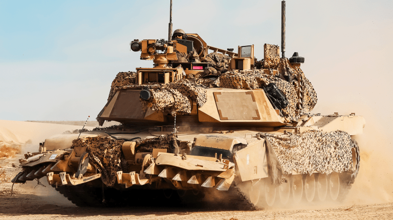 U.S. Soldiers maneuver a M1 Abrams main battle tank into a breaching position during Rotation 25-04 at the National Training Center, Fort Irwin, Calif., Feb. 9, 2025.