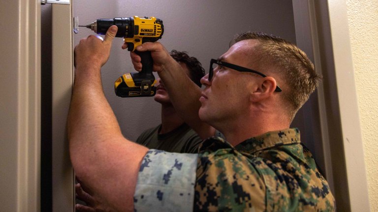 U.S. Marine Corps Gunnery Sgt. Jason Myers, an operations chief with 1st Radio Battalion, I Marine Expeditionary Force Information Group, replaces a towel rack during Operation Clean Sweep III at Marine Corps Base Camp Pendleton, California, Sept. 26, 2025. Operation Clean Sweep III, part of the ongoing Barracks 360 Reset Initiative, demonstrates a collective commitment to improving living conditions through shared ownership, sustained accountability, and tangible improvements to the barracks. (U.S. Marine Corps photo by Cpl. Manuel Rivera)