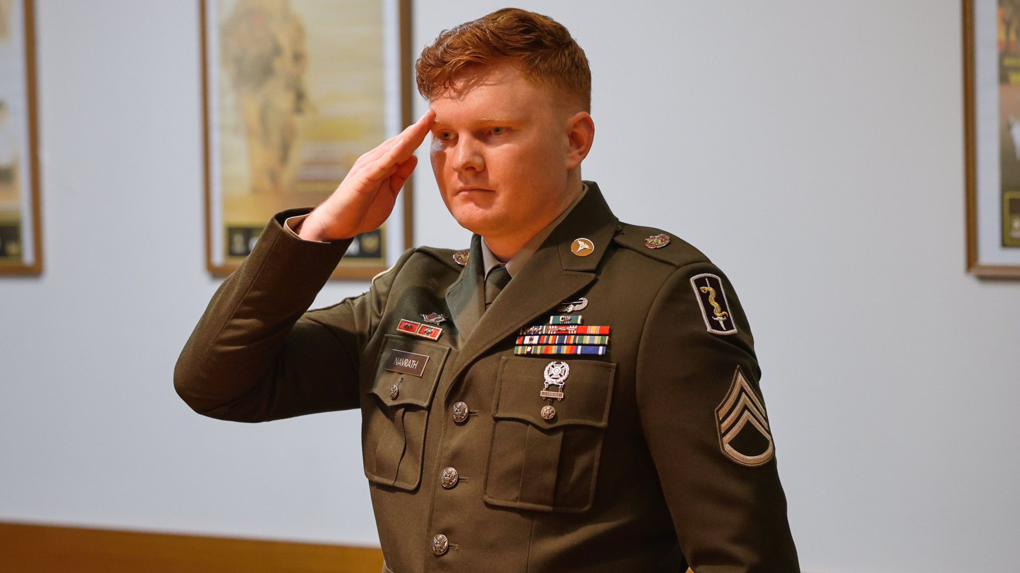 U.S. Army Staff Sgt. Dakota Navrath, assigned to the 421st Medical Battalion-Multifunctional, 30th Medical Brigade, reports to the board president during a Sgt. Morales Club board hosted by 21st Theater Sustainment Command, on Panzer Kaserne, Kaiserslautern, Germany, Feb. 12, 2025. Board members interview each candidate, seeking noncommissioned officers who will go the extra mile for their Soldiers by looking beyond problems to find solutions. (U.S. Army photo by Staff Sgt. Daniel Yeadon)