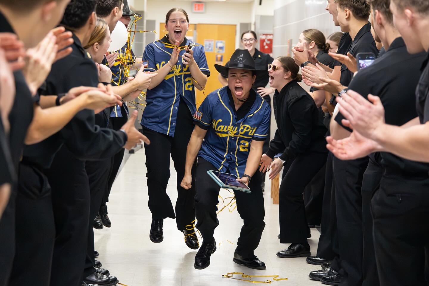 Two Naval Academy seniors celebrate their selection as Navy Pilots.