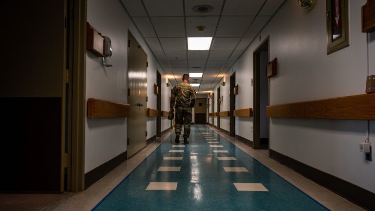 A National Guard soldier, walks down the hallway at a hospital in April 2020.